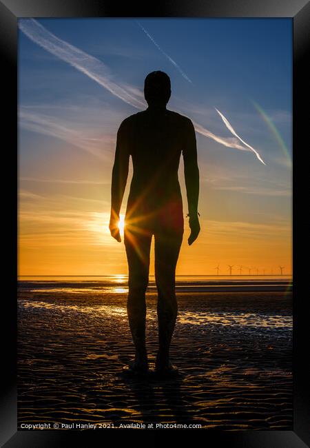 A lonely figure stands silent on Crosby beach Framed Print by Paul Hanley