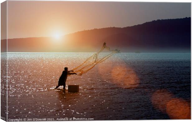 A Thai fisherman at sunrise Canvas Print by Jim O'Donnell