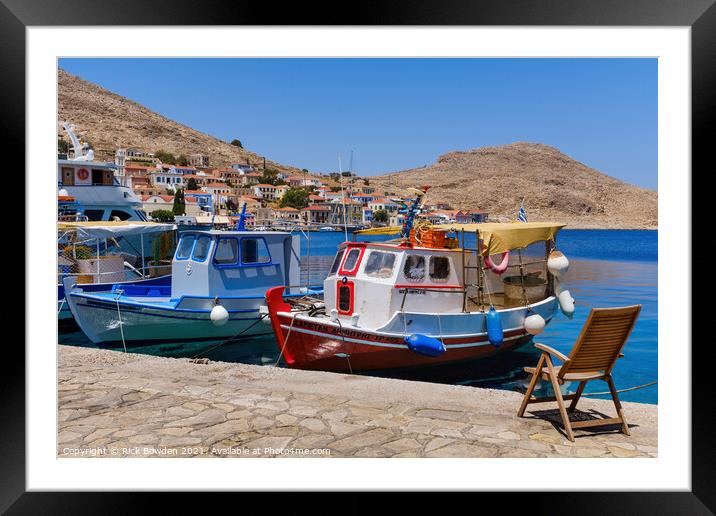 Halki Boats and Chair Framed Mounted Print by Rick Bowden