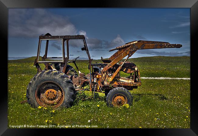 Tractor on green field Framed Print by Gabor Pozsgai