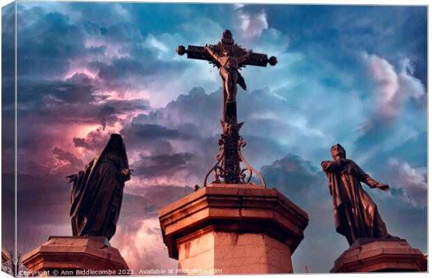 Christ statue with stormy sky Canvas Print by Ann Biddlecombe