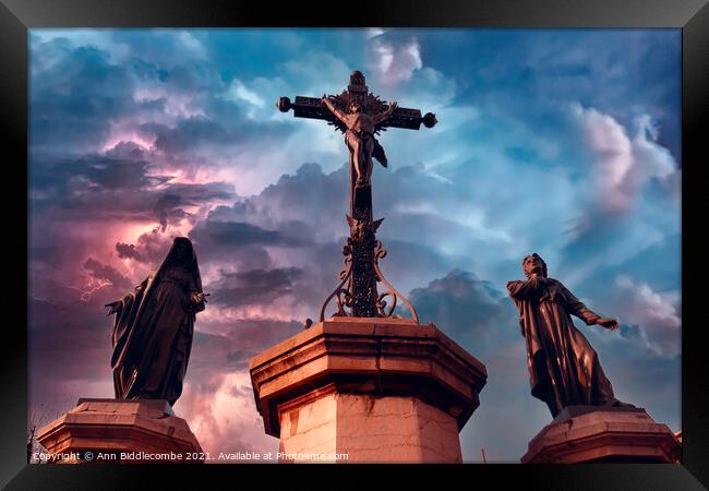 Christ statue with stormy sky Framed Print by Ann Biddlecombe