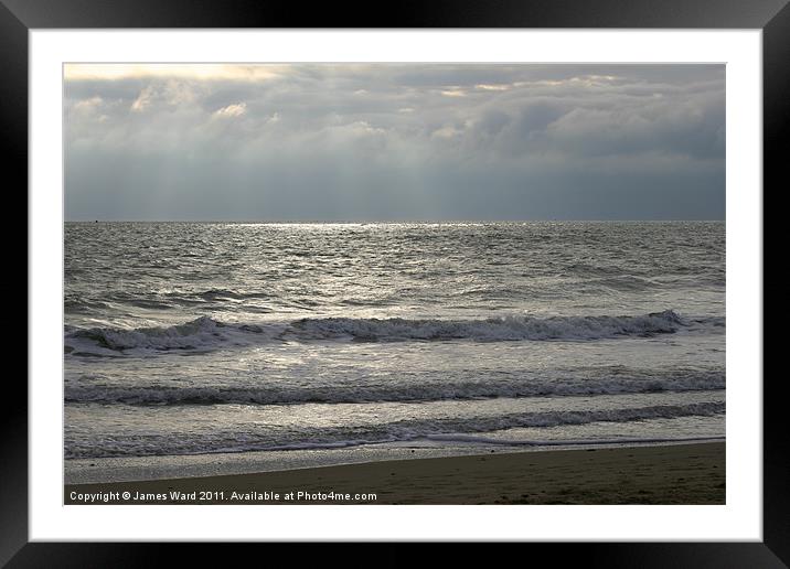 Lapping waves at the beach Framed Mounted Print by James Ward