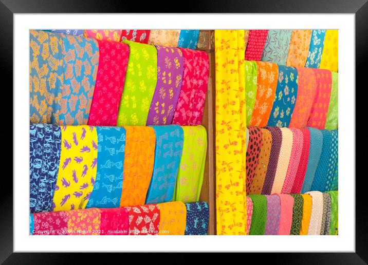Bolts of colourful cloth hanging in a shop in Denpasar, Bali, In Framed Mounted Print by Kevin Hellon