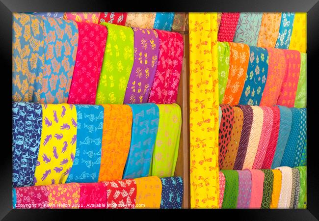 Bolts of colourful cloth hanging in a shop in Denpasar, Bali, In Framed Print by Kevin Hellon