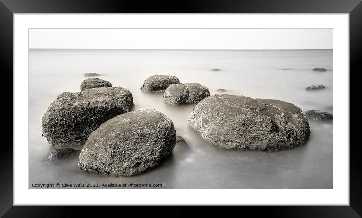 Boulders on smooth sea Framed Mounted Print by Clive Wells