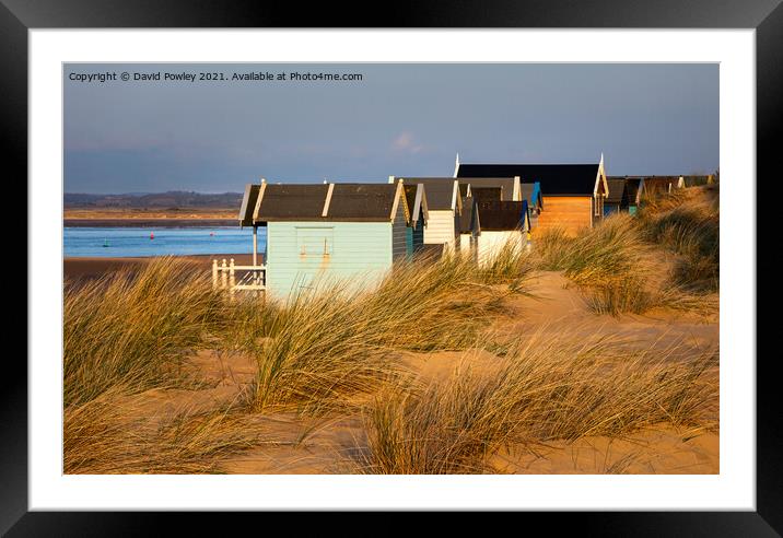 Evening Light on the Beach Huts at Wells  Framed Mounted Print by David Powley