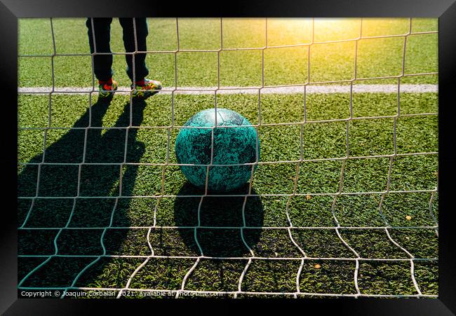 Soccer ball entering a goal defended by a goalkeeper, copy space Framed Print by Joaquin Corbalan