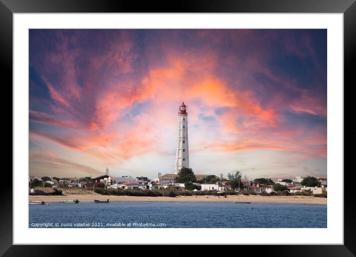 Beautiful lighthouse overlooking the ocean at suns Framed Mounted Print by nuno valadas