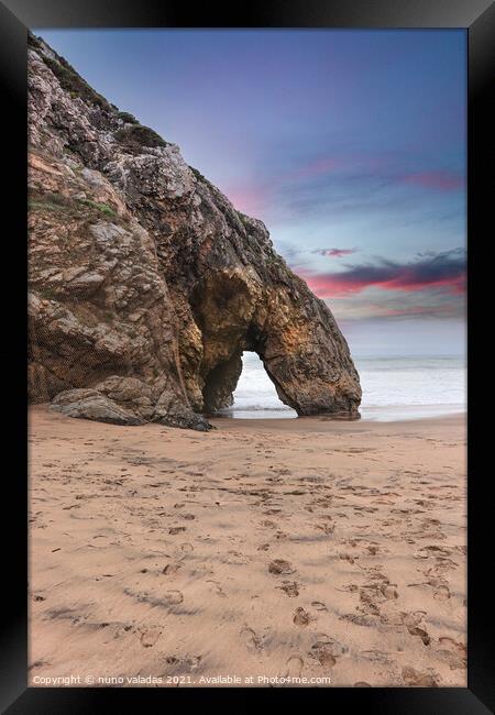 Beautiful stone natural arche. Rock formation in a beach with ocean in background at the sunset Framed Print by nuno valadas