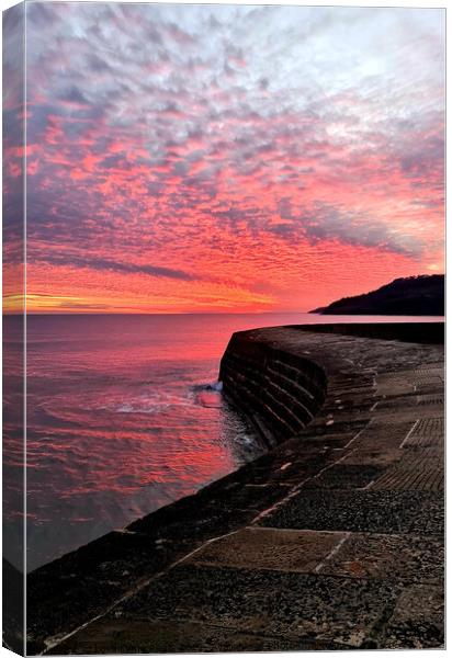 Fiery sunset over the Cobb in Lyme Regis Canvas Print by Love Lyme Regis