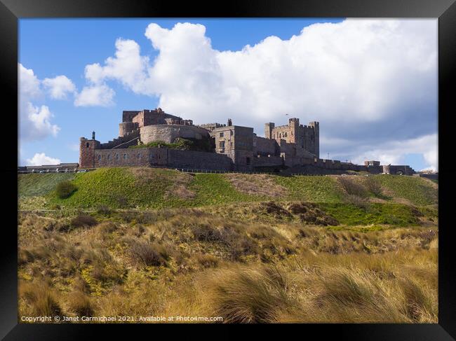 Bamburgh Castle and Dunes Framed Print by Janet Carmichael