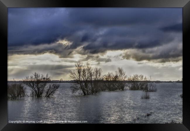 Turbulent skies over Welches Dam, Cambridgeshire Framed Print by Murray Croft