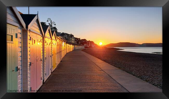Beach huts at sunrise in Lyme Regis Framed Print by Love Lyme Regis