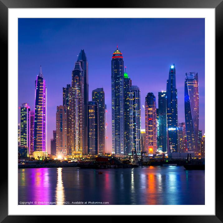 Dubai marina skyline illuminated at night, UAE Framed Mounted Print by Delphimages Art