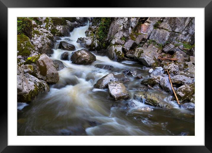 Sticks and stones and flowing water Framed Mounted Print by Leighton Collins
