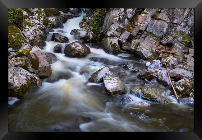 Sticks and stones and flowing water Framed Print by Leighton Collins