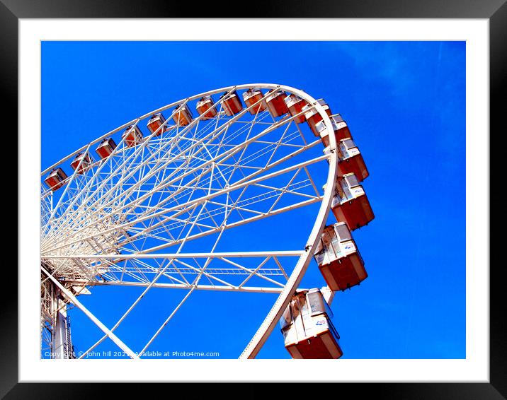 Ferris wheel against a blue sky. Framed Mounted Print by john hill