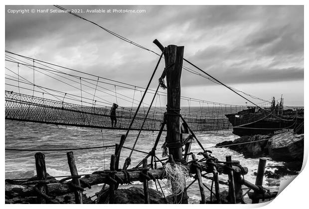 A man on a swinging rope foot bridge. Print by Hanif Setiawan