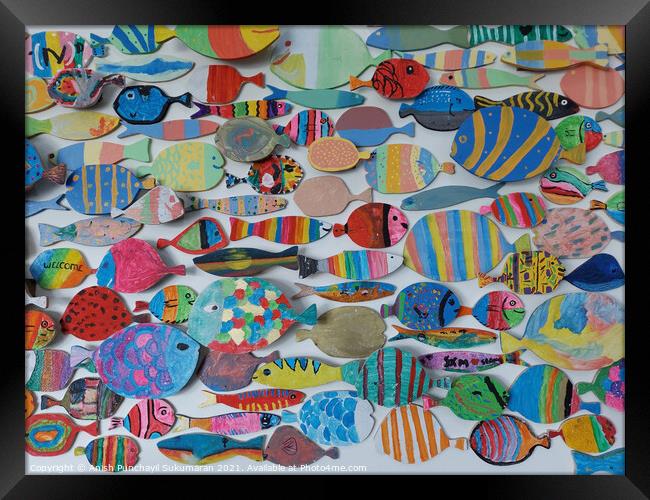 beautiful and colourful wooden fish wood craft on wall Framed Print by Anish Punchayil Sukumaran
