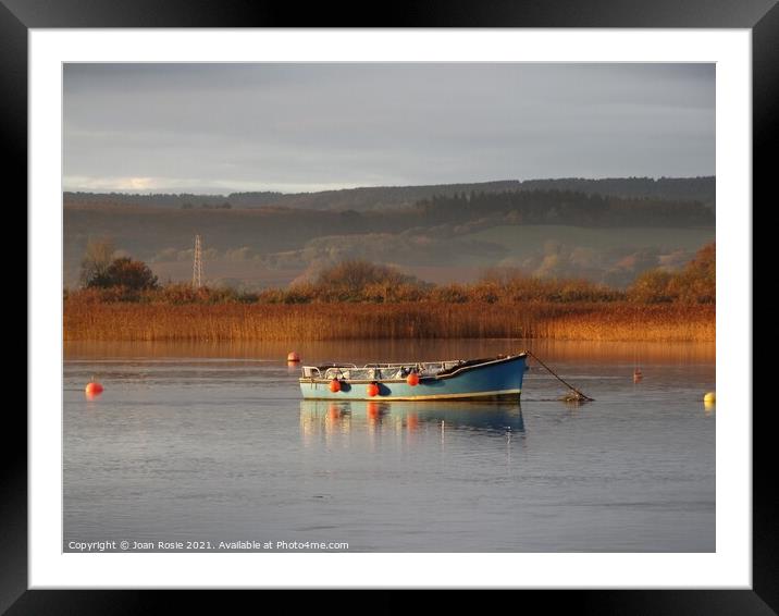 Blue boat on the Exe Estuary in early morning winter sunlight Framed Mounted Print by Joan Rosie