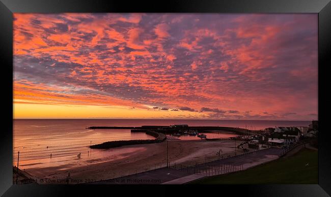 Spectacular sunrise sky over the Cobb Lyme Regis Framed Print by Love Lyme Regis