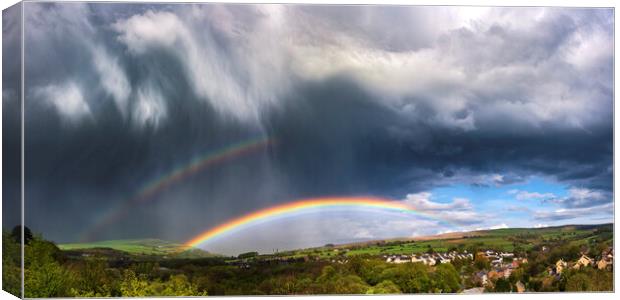 Dramatic skies over Derbyshire with double rainbow Canvas Print by John Finney