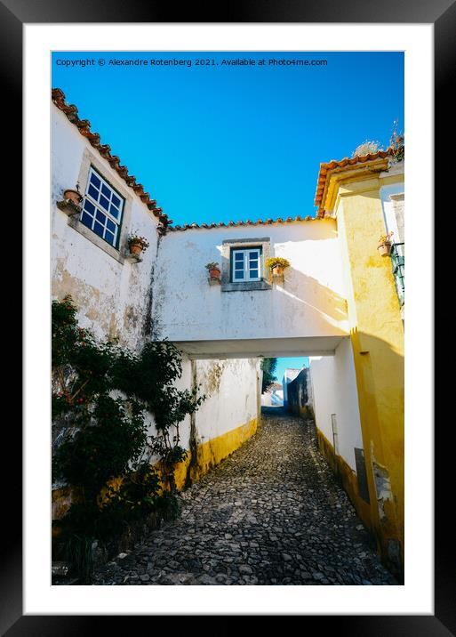 Narrow cobbled streets and traditionally painted houses in Obidos, Portugal. Framed Mounted Print by Alexandre Rotenberg