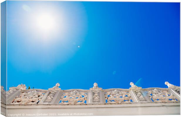 Old style stone balustrade, bottom view with blue sky background Canvas Print by Joaquin Corbalan