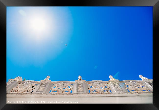 Old style stone balustrade, bottom view with blue sky background Framed Print by Joaquin Corbalan