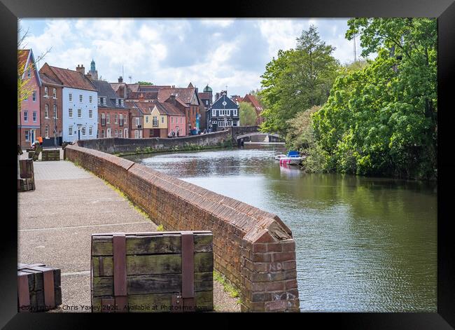 Norwich, Norfolk, UK – May 11 2021. The historic Quayside along the River Wensum in the city of Norwich, Norfolk. The traditional properties along this pedestrianised road have stunning interrupted views across the River Wensum all the way to Fye Bridge Framed Print by Chris Yaxley