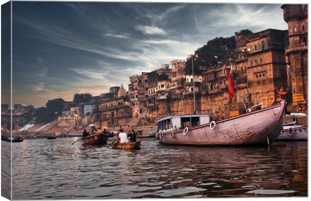 Varanasi, India: Dramatic sunset in a holy hindu place of worship with lots of tourists on boats and ancient architecture ghat located in Uttar pradesh. Canvas Print by Arpan Bhatia