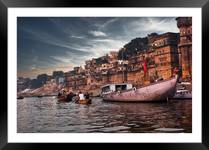 Varanasi, India: Dramatic sunset in a holy hindu place of worship with lots of tourists on boats and ancient architecture ghat located in Uttar pradesh. Framed Mounted Print by Arpan Bhatia