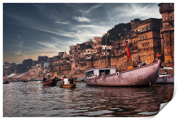 Varanasi, India: Dramatic sunset in a holy hindu place of worship with lots of tourists on boats and ancient architecture ghat located in Uttar pradesh. Print by Arpan Bhatia