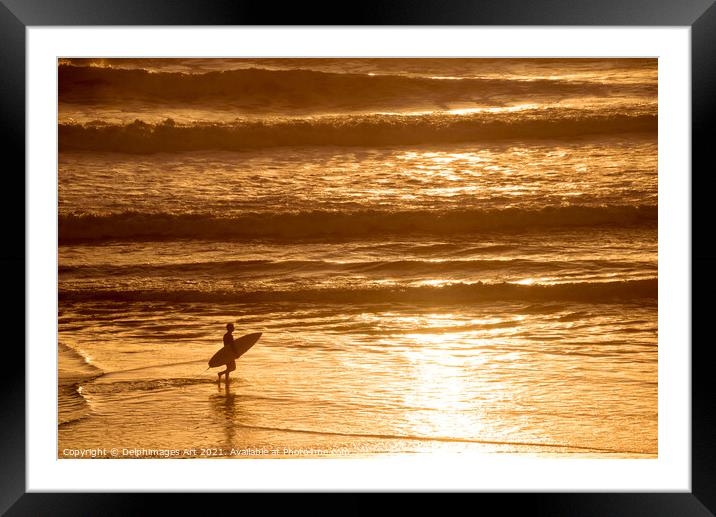 Silhouette of a surfer at sunset in the ocean Framed Mounted Print by Delphimages Art
