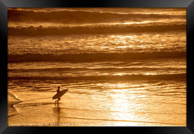 Silhouette of a surfer at sunset in the ocean Framed Print by Delphimages Art