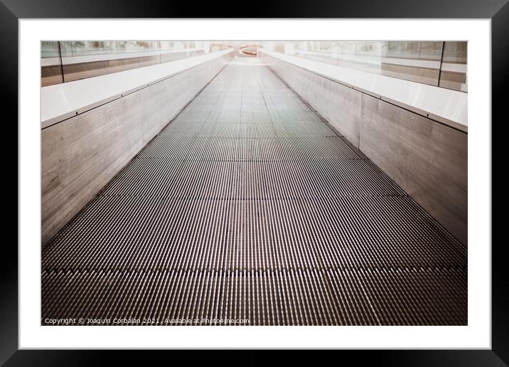 Flat escalator in a shopping mall without people, luminous unfoc Framed Mounted Print by Joaquin Corbalan