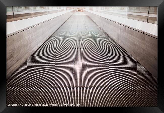 Flat escalator in a shopping mall without people, luminous unfoc Framed Print by Joaquin Corbalan