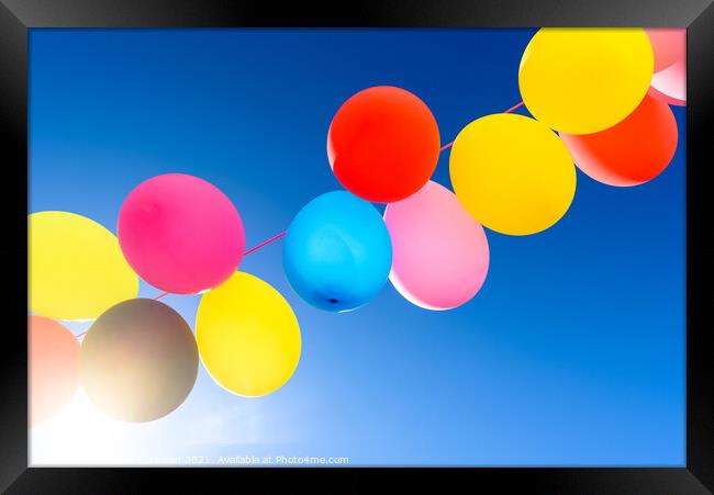 Pretty sunlit solid color balloons viewed from below with blue s Framed Print by Joaquin Corbalan