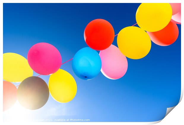 Pretty sunlit solid color balloons viewed from below with blue s Print by Joaquin Corbalan