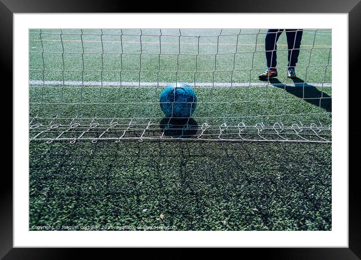Soccer player in a goal tries to stop a ball, background with co Framed Mounted Print by Joaquin Corbalan