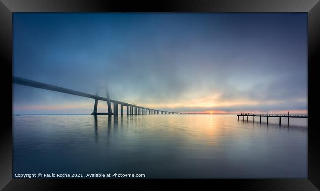 Long bridge over tagus river in Lisbon at sunrise with fog Framed Print by Paulo Rocha