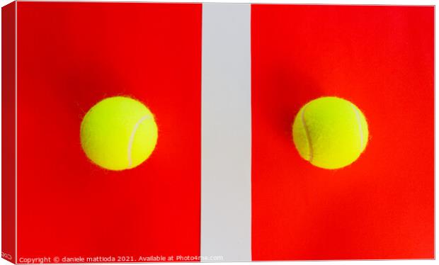 two tennis balls divided by a field line Canvas Print by daniele mattioda