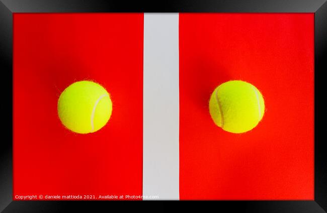 two tennis balls divided by a field line Framed Print by daniele mattioda