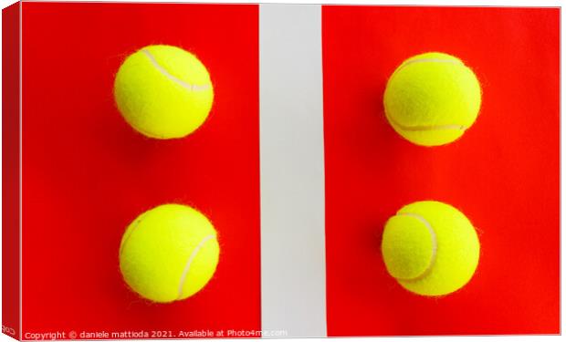 four tennis balls divided by a field line Canvas Print by daniele mattioda