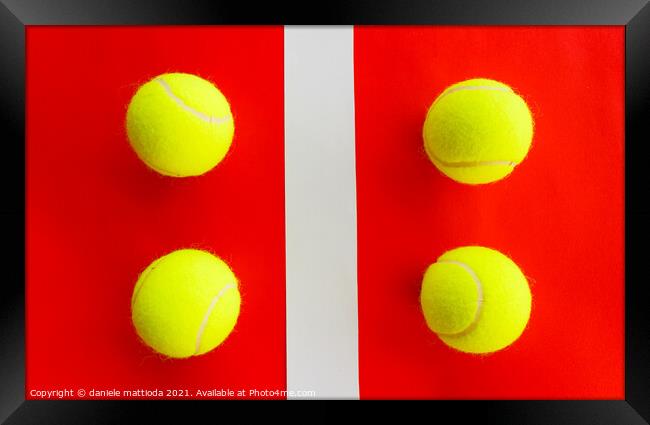 four tennis balls divided by a field line Framed Print by daniele mattioda