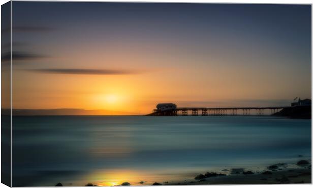 Sunrise overlooking the sea and Mumbles Pier in Swansea Canvas Print by Alan Le Bon