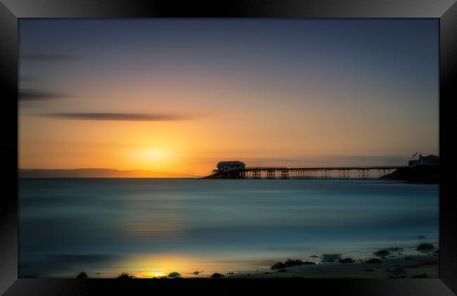 Sunrise overlooking the sea and Mumbles Pier in Swansea Framed Print by Alan Le Bon