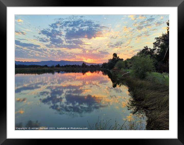 Cloudy reflections over lake Framed Mounted Print by Adrian Paulsen