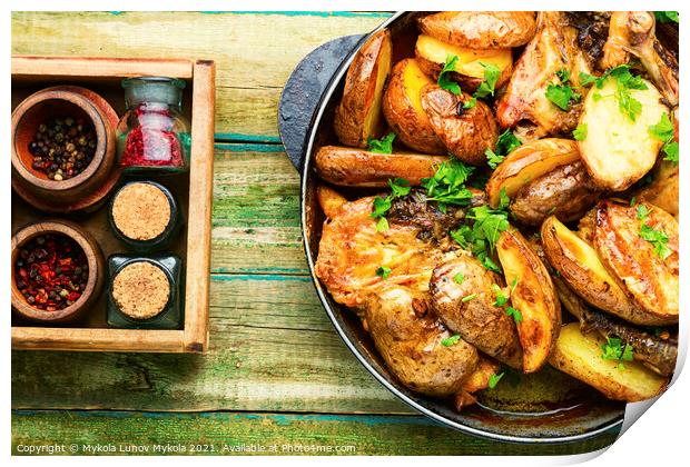 Chicken baked with potatoes in a iron cast pan Print by Mykola Lunov Mykola